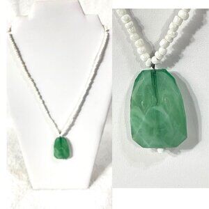 White bead and green pendant necklace.